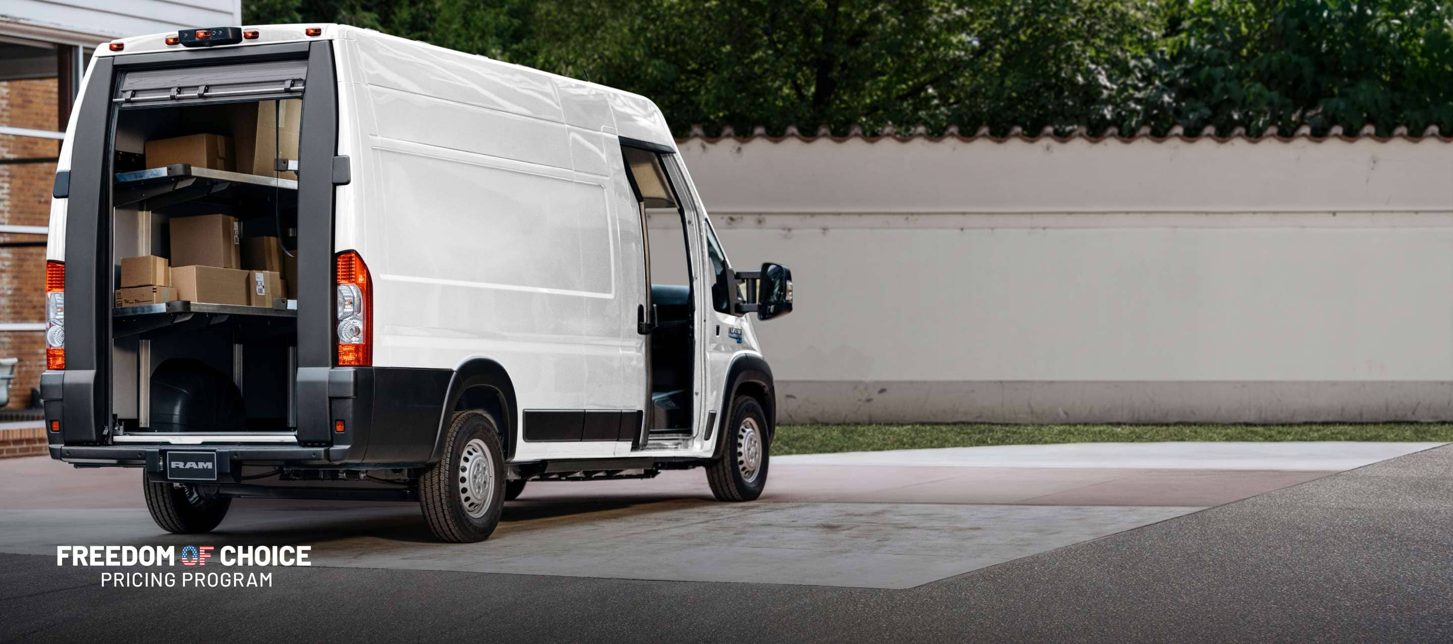 A rear passenger-side angle of a white 2024 Ram ProMaster EV Step Van Super High Roof with its rear roll-up door raised and passenger sliding pocket door open. Freedom Of Choice Pricing Update Sales Event.