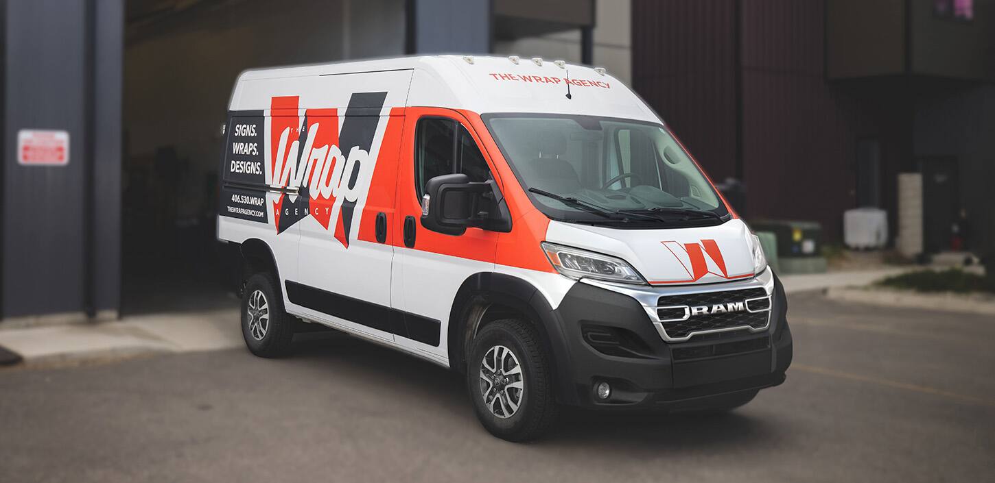 Display An angled passenger-side profile of a 2024 Ram ProMaster 2500 SLT Cargo Van High Roof, with a custom paint job in white and red, and company signage on the side panel.