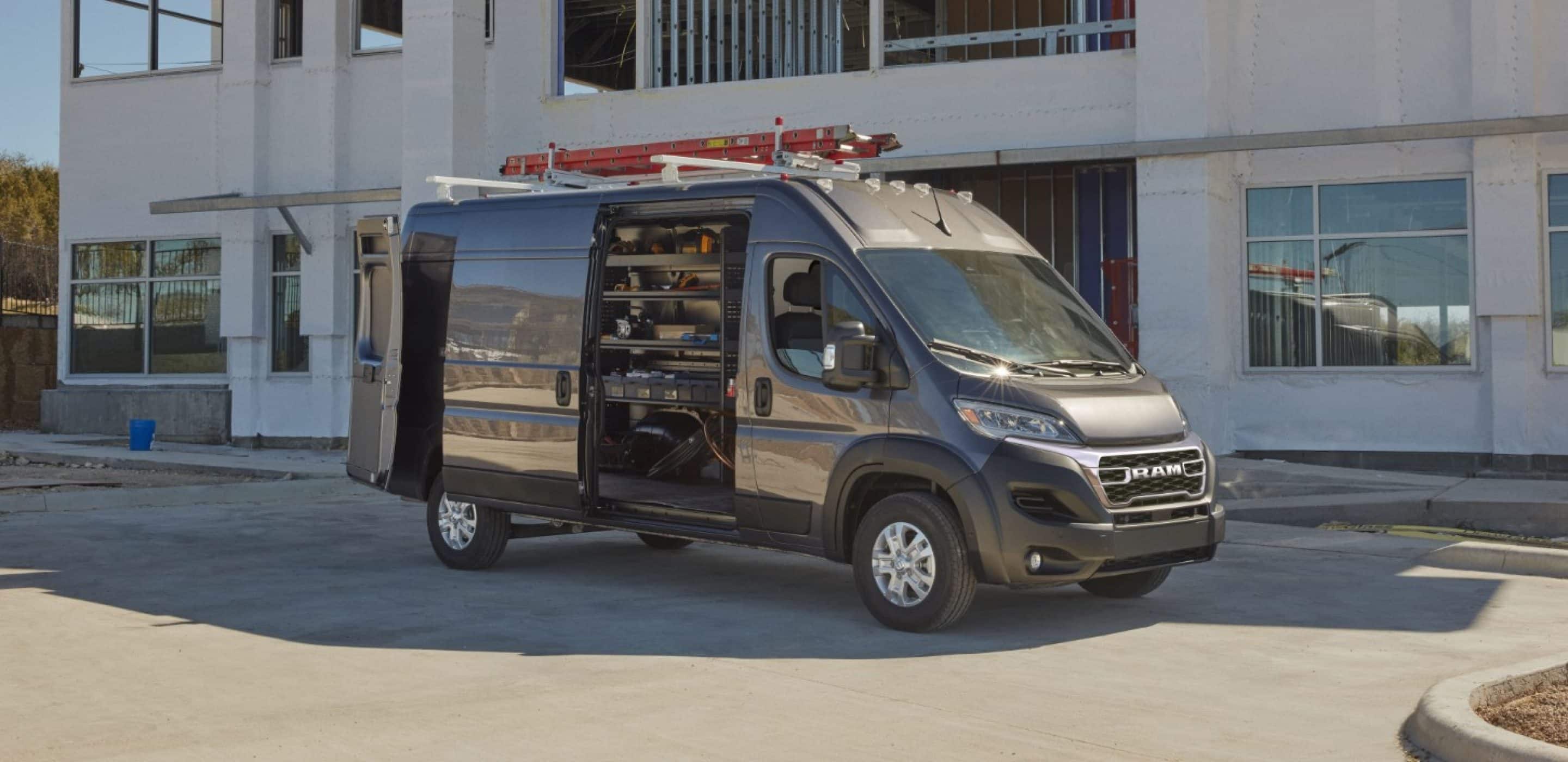 2024 ram promaster with door open showing shelves of tools and equipment. 