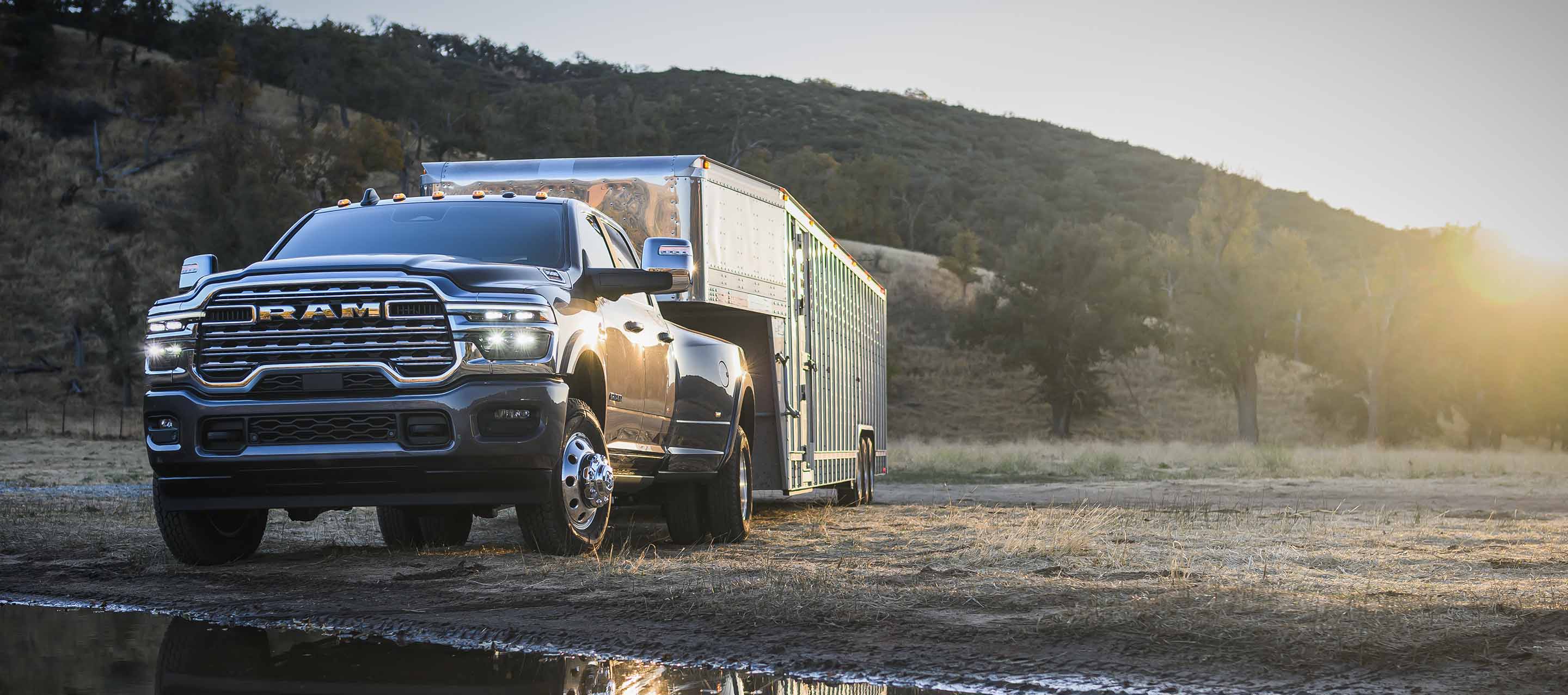 A black 2025 Ram 3500 Limited Longhorn 4x4 Crew Cab towing a livestock trailer. 36,610-pound available maximum diesel towing capacity.