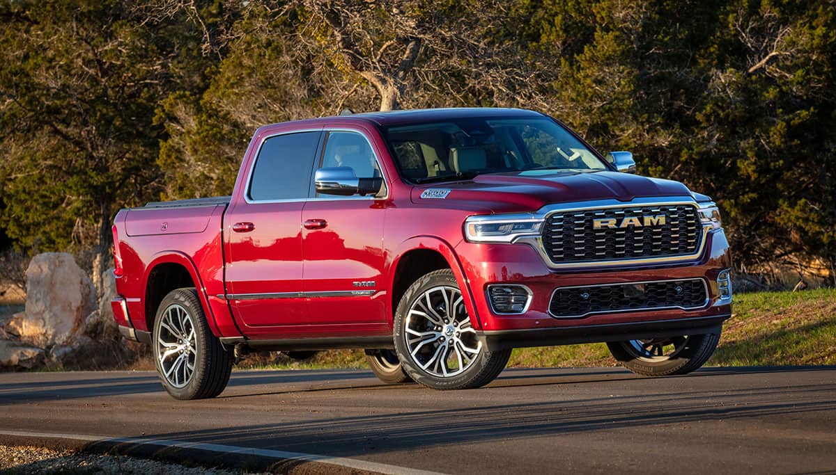 Display A red 2025 Ram 1500 Tungsten Crew Cab being driven on a highway.