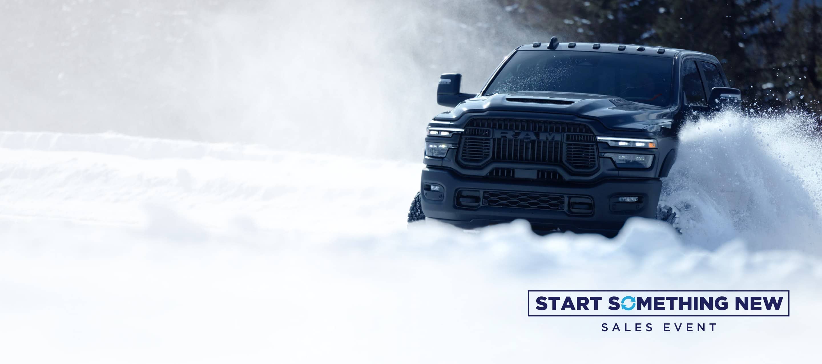A gray 2025 Ram 2500 Rebel 4x4 Crew Cab traveling through deep snow in a forest. Start Something New Event.