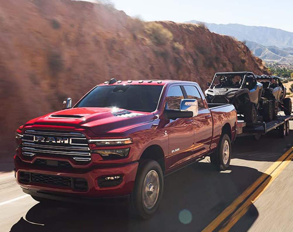 2025 Red RAM 2500 towing 2 side by side ATV's