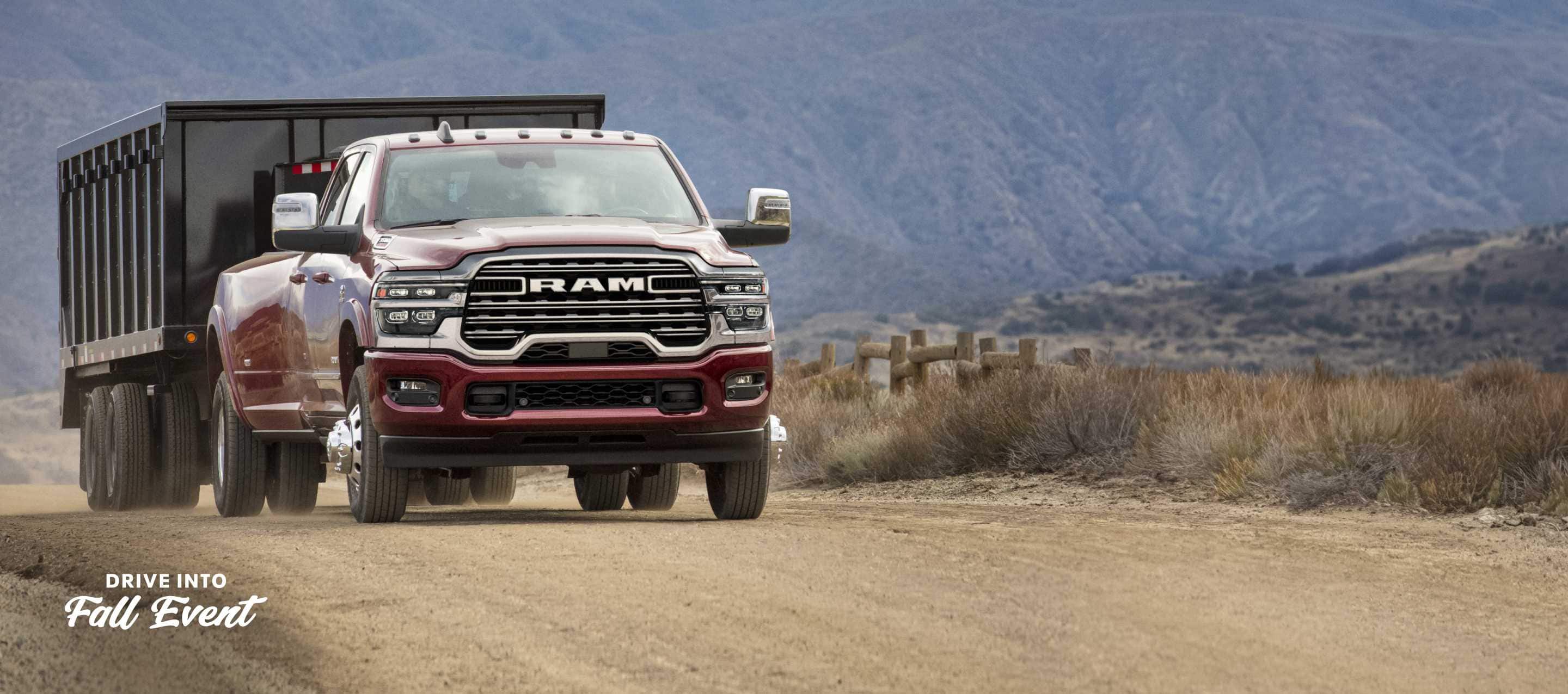 A red 2025 Ram 3500 Laramie 4x4 Crew Cab towing an enclosed box. Drive Into Fall Sales Event.