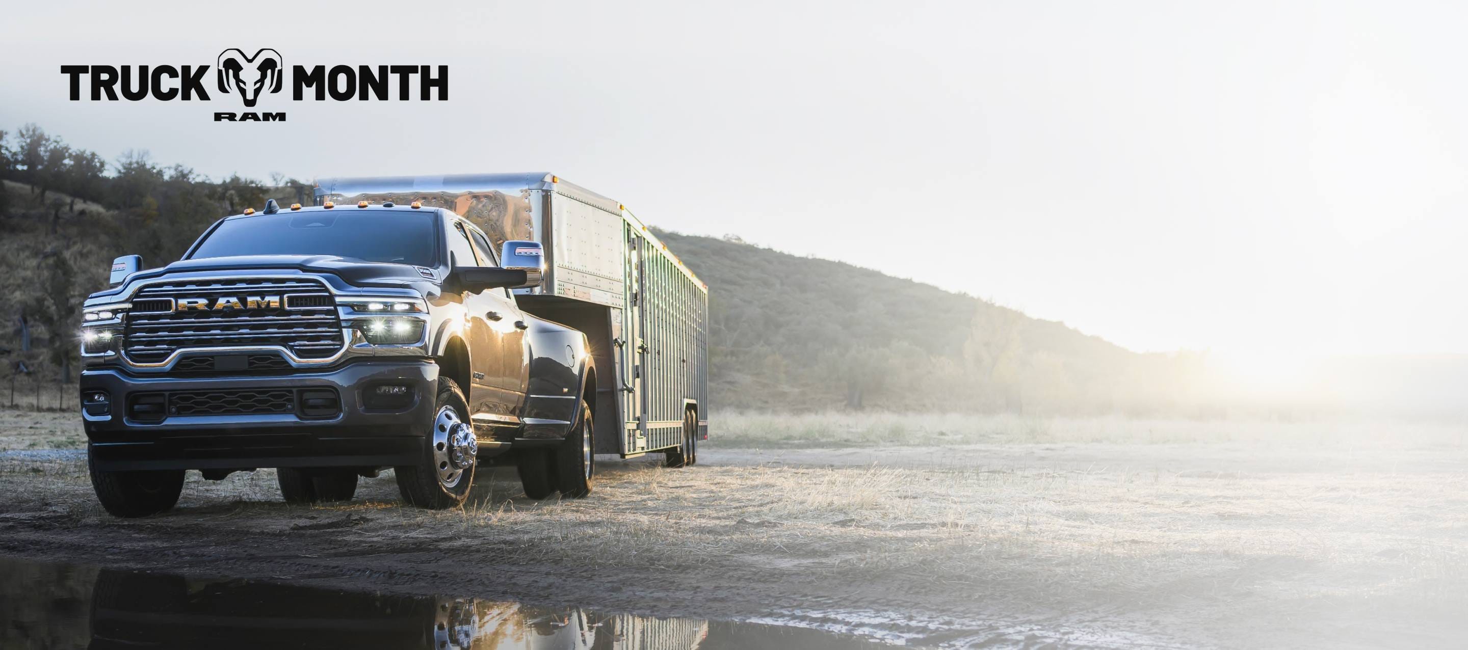 A red 2025 Ram 3500 Laramie 4x4 Crew Cab towing an enclosed box. Truck of The Month Sales Event.