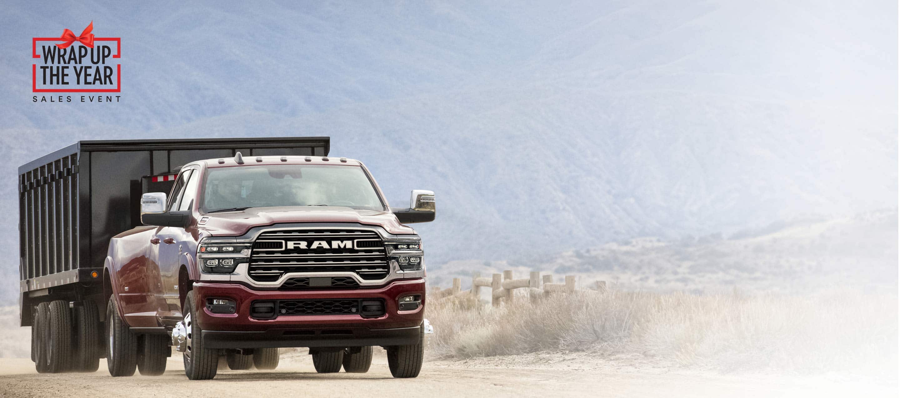 A red 2025 Ram 3500 Laramie 4x4 Crew Cab towing an enclosed box. Wrap Up The Year Sales Event.