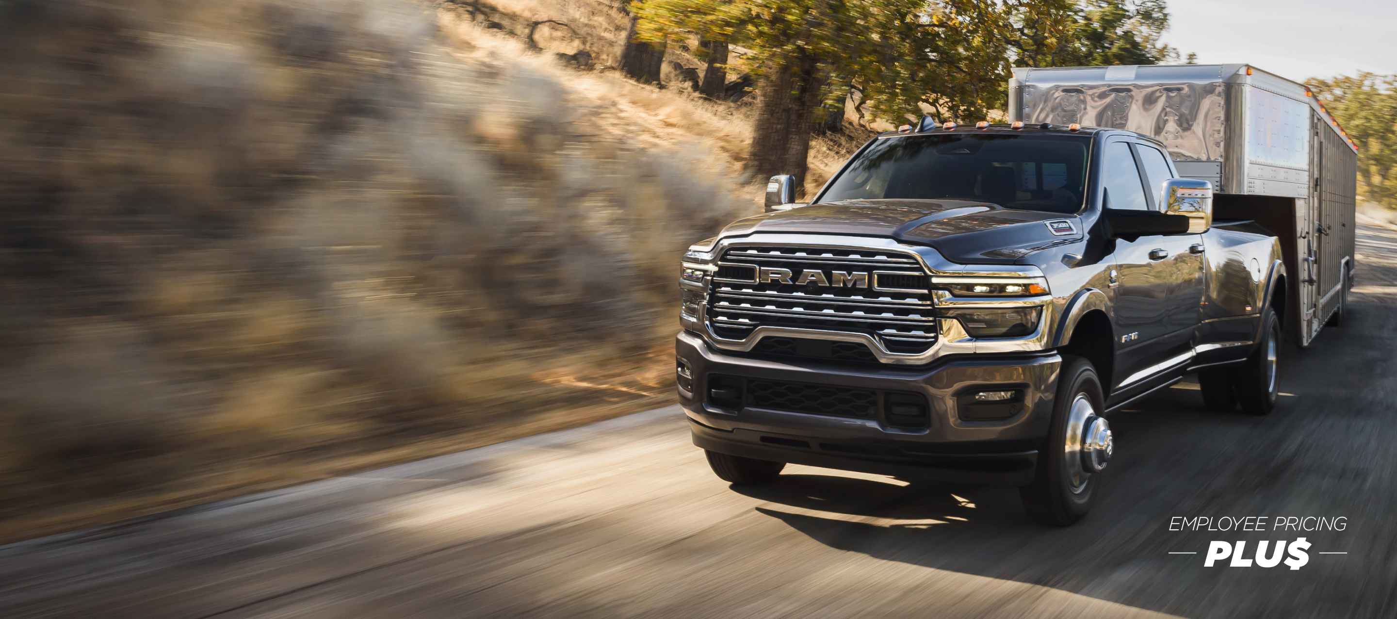 A gray 2025 Ram 3500 Limited Longhorn 4x4 Crew Cab towing a large fifth-wheel livestock trailer. Employee Pricing Plus Sales Event.