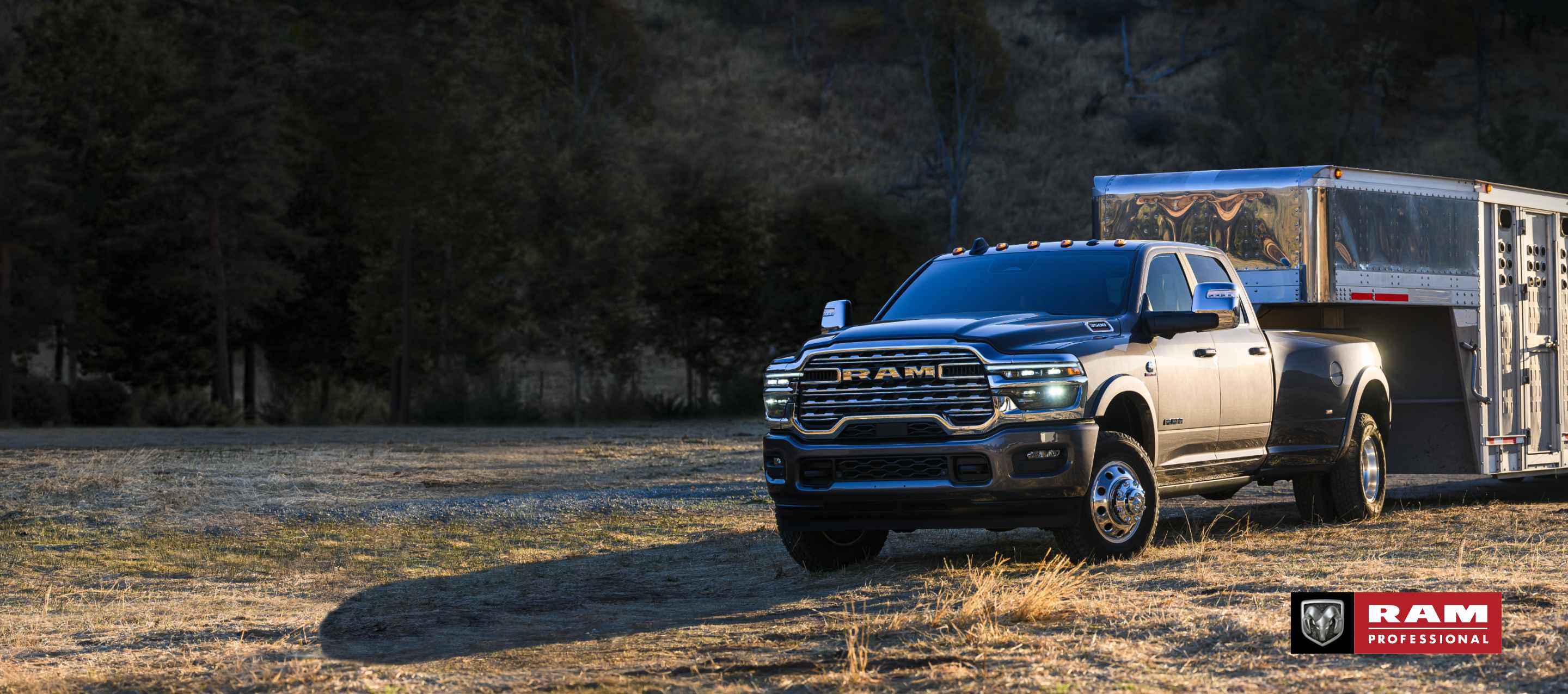 A gray 2025 Ram 3500 Limited Longhorn 4x4 Crew Cab towing a large fifth-wheel livestock trailer. Ram Professional.