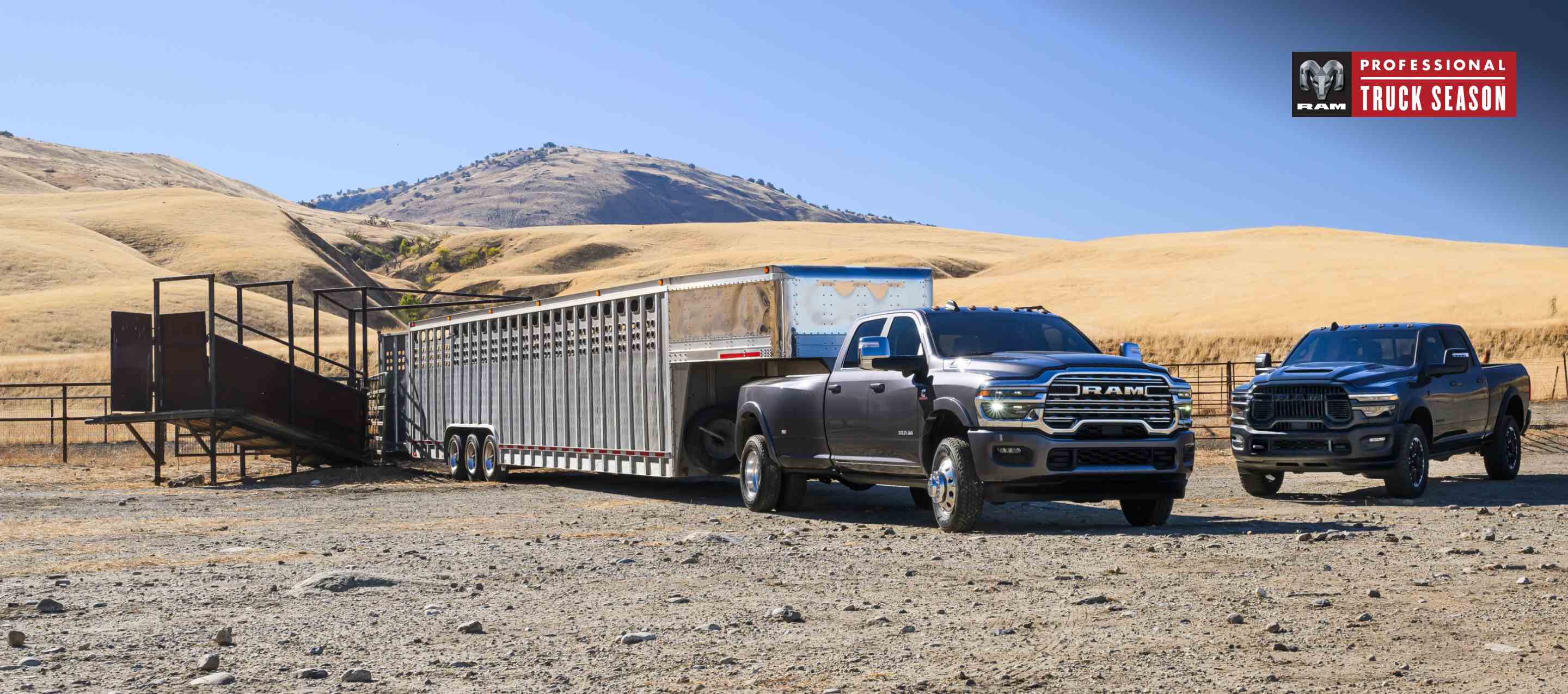 A 2025 Ram 3500 Limited Longhorn 4x4 Crew Cab towing a large fifth-wheel livestock trailer and a black Ram 2500 Rebel 4x4 Crew Cab parked near each other. Ram Professional Truck Season.
