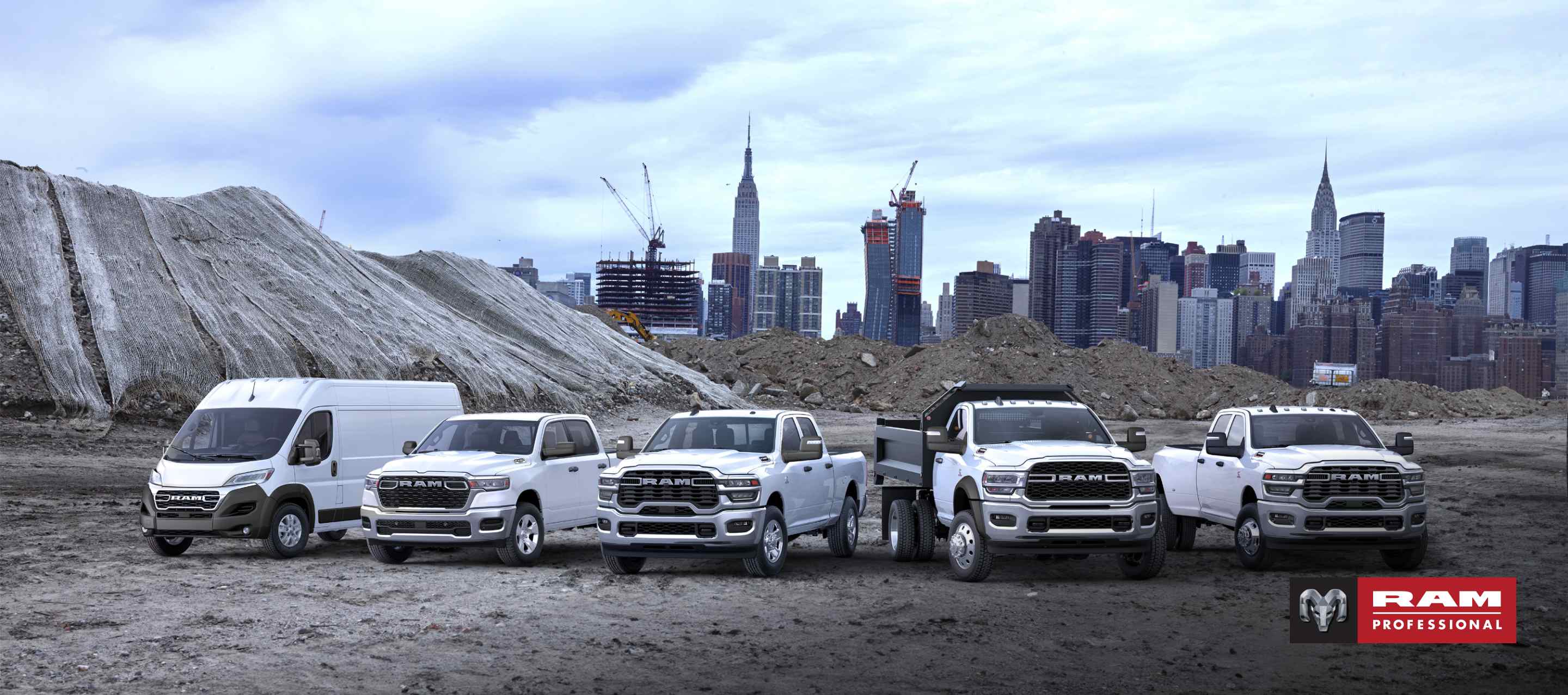 The 2025 Ram Brand lineup all in white, parked side-by-side at at a pre-construction site, with a cityscape in the background. From left to right: a Ram ProMaster 3500 SLT High Roof Cargo Van, a Ram 1500 Tradesman 4x4 Crew Cab, a 2024 Ram 2500 Tradesman 4x4 Crew Cab, a 2024 Ram 5500 Tradesman Chassis Regular Cab with dump body upfit and a 2024 Ram 3500 Tradesman 4x4 Crew Cab. Ram Professional.