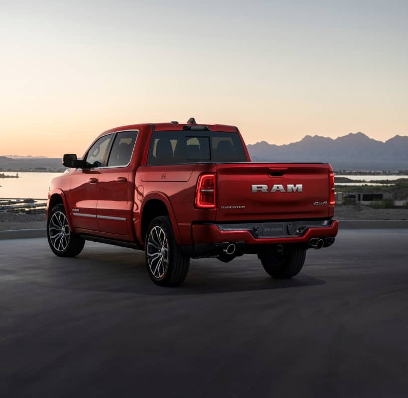 Silver pickup truck parked on a road, representative of a Ram truck ready for work or the road
