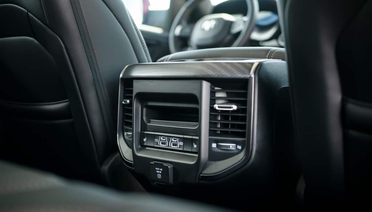 Display The rear seat climate controls, USB ports and cubby bin on the back of the center console in the 2026 Ram 1500 Rebel.