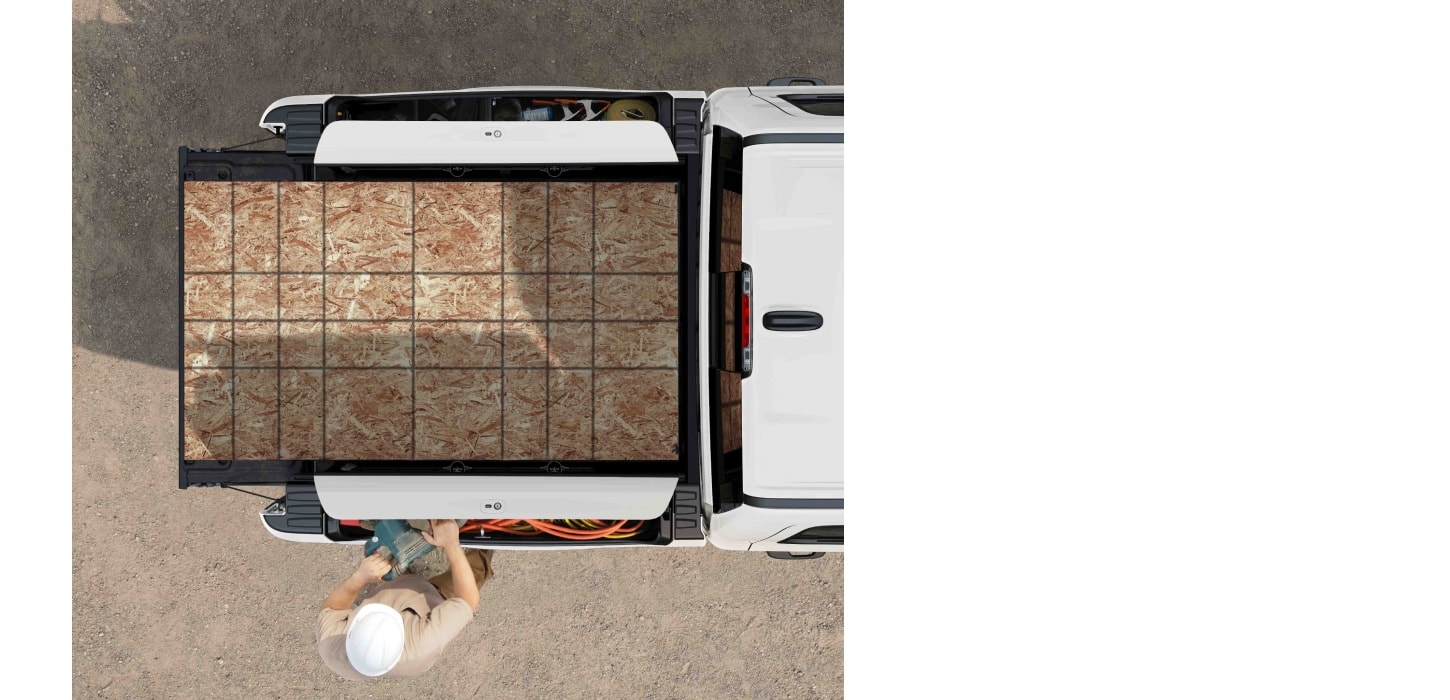 An overhead angle of the 2026 Ram 1500 pickup box filled with sheets of plywood.