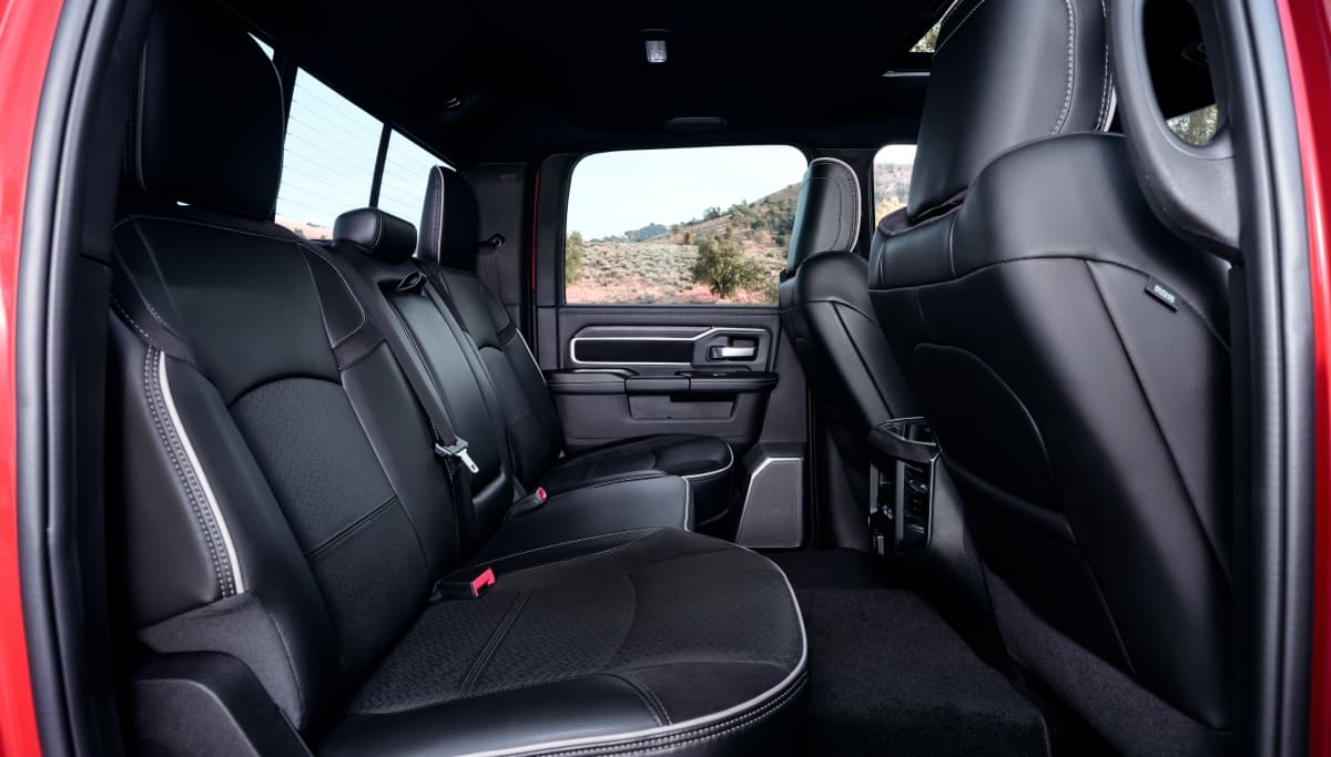 Display The rear seats in a red 2026 Ram 2500 Laramie.