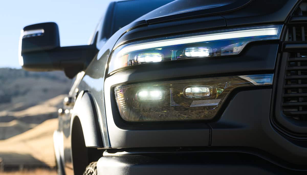 Display The passenger-side headlamp on a dark gray 2026 Ram 2500 Rebel.
