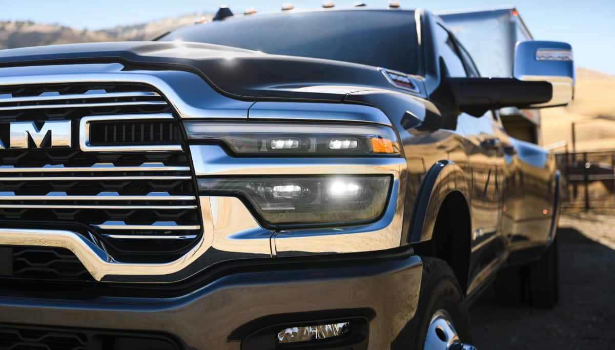 Display A part of the grille and driver-side headlamp on a black 2026 Ram 3500 Limited Longhorn.