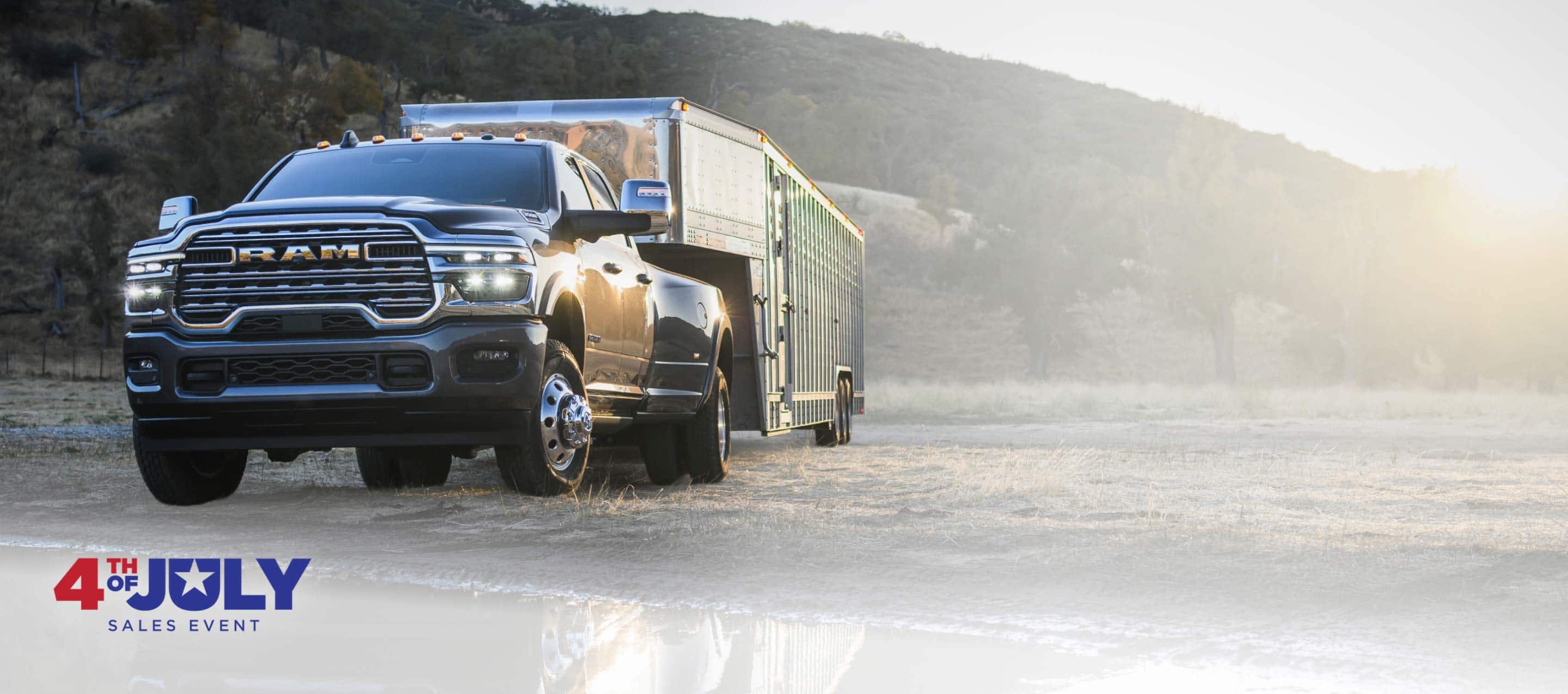 A black 2026 Ram 3500 Limited Longhorn 4x4 Crew Cab heavy-duty pickup towing a large livestock trailer. 4th of July Sales.