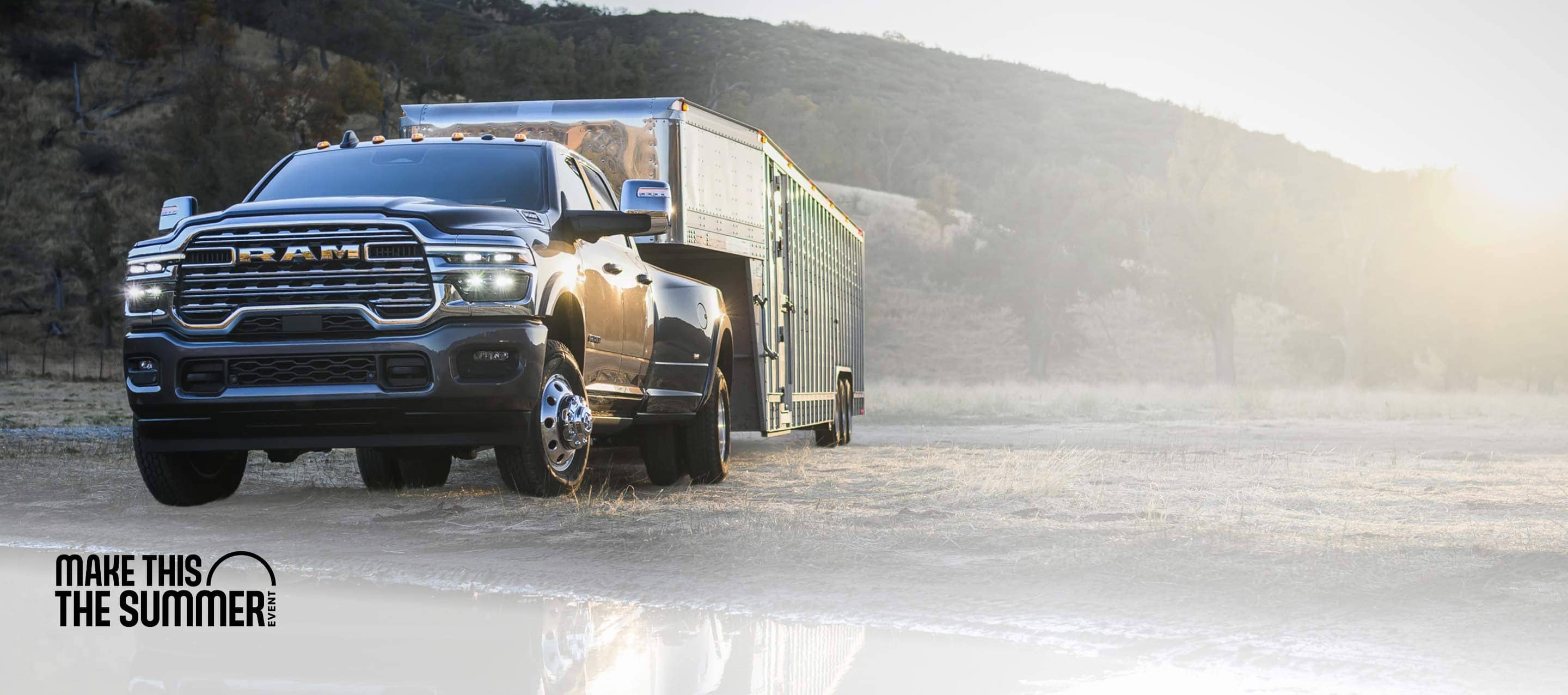 A black 2026 Ram 3500 Limited Longhorn 4x4 Crew Cab heavy-duty pickup towing a large livestock trailer. Make this the summer event.