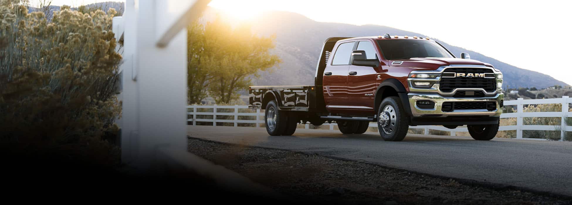 A red 2026 Ram 4500 Big Horn Chassis Cab Crew Cab with a long platform upfit.