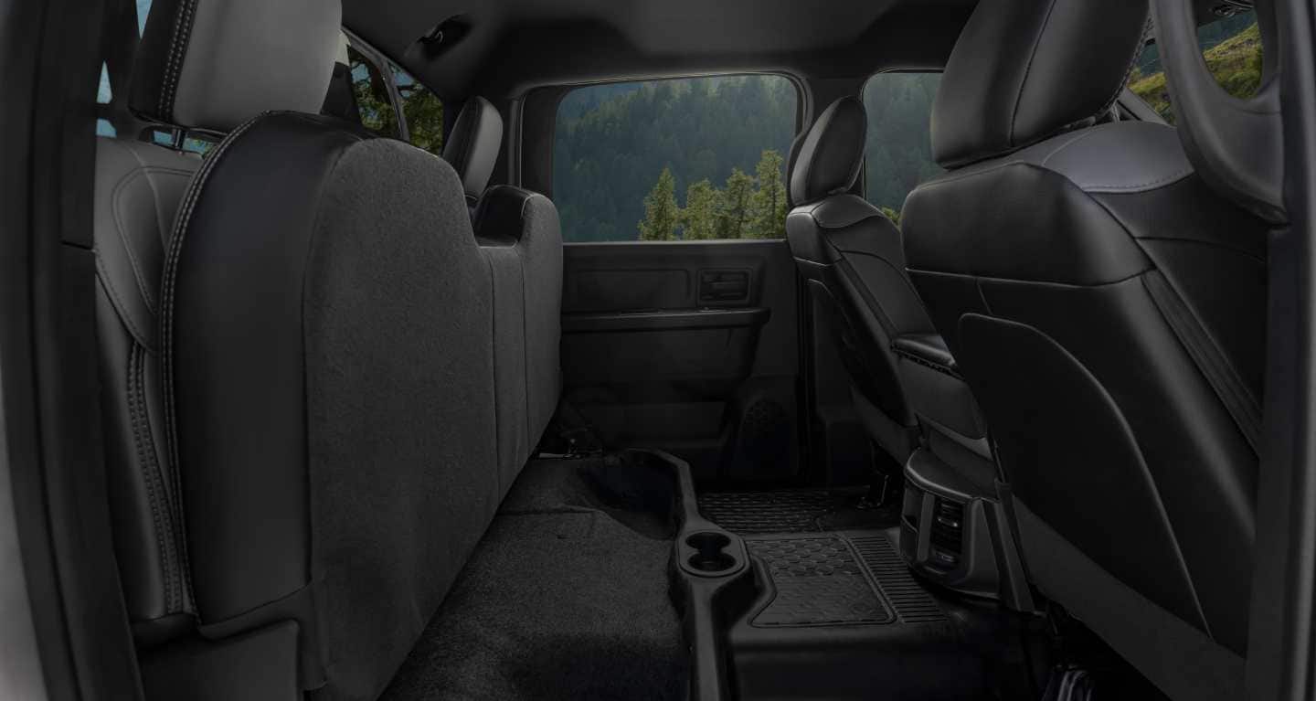 Display The rear seat cushions lifted to reveal the under-seat storage in the 2026 Ram Chassis Cab.