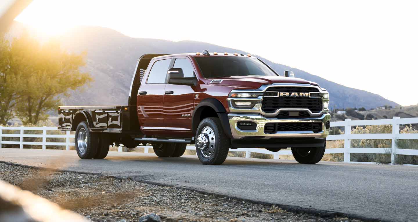 Display A red 2026 Ram 4500 Big Horn Chassis Cab Crew Cab with a long platform upfit.