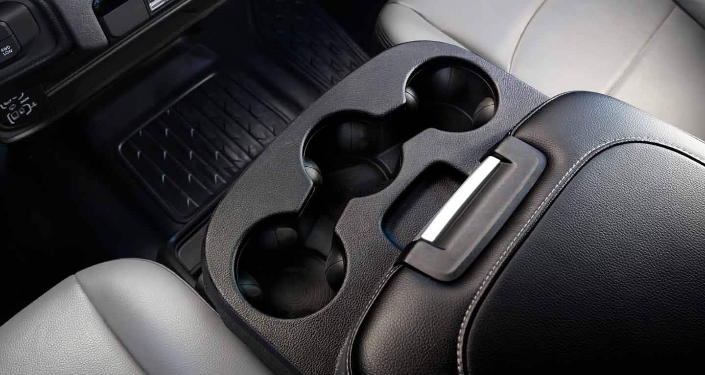 Display The reconfigurable center console in the 2026 Ram Chassis Cab with sliding cup holders, a smartphone docking area and dual wireless charging pad.