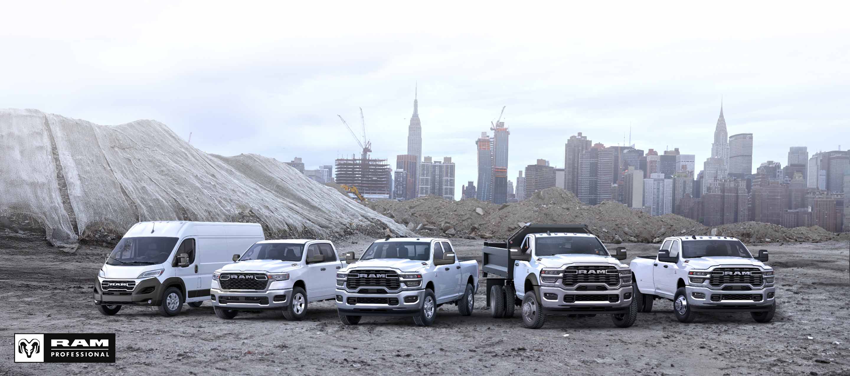 A lineup of Ram trucks and vans, all in white at a commercial construction site. From left to right: a Ram ProMaster 3500 SLT High Roof Cargo Van, a Ram 1500 Tradesman 4x4 Crew Cab, a Ram 2500 Tradesman 4x4 Crew Cab, a Ram 4500 Big Horn Regular Cab Chassis Cab with a dump body upfit and a Ram 3500 Tradesman 4x4 Crew Cab. Ram Professional.