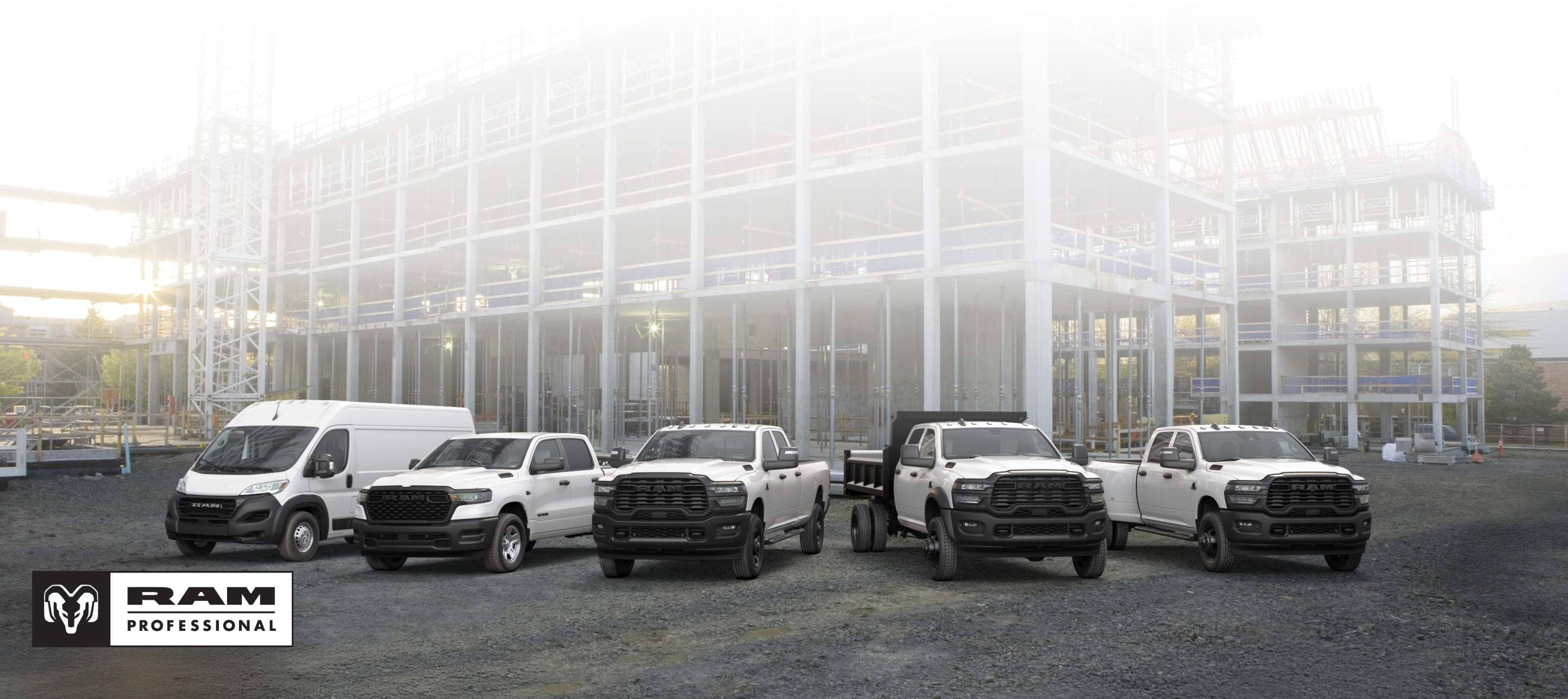 A lineup of 2026 Ram trucks and vans, all in white at a commercial construction site. From left to right: a Ram ProMaster 3500 Tradesman High Roof Cargo Van, a Ram 1500 Tradesman 4x4 Crew Cab, a Ram 2500 Tradesman 4x4 Crew Cab, a Ram 3500 Tradesman Crew Cab Chassis Cab with a dump body upfit and a Ram 3500 Tradesman 4x4 Crew Cab.