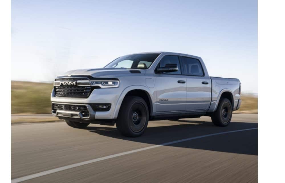 Silver Ram 1500 REV driving on a highway