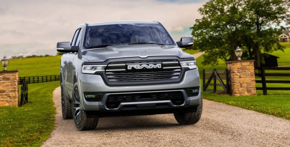 Gray Ram 1500 REV, front view on a country driveway