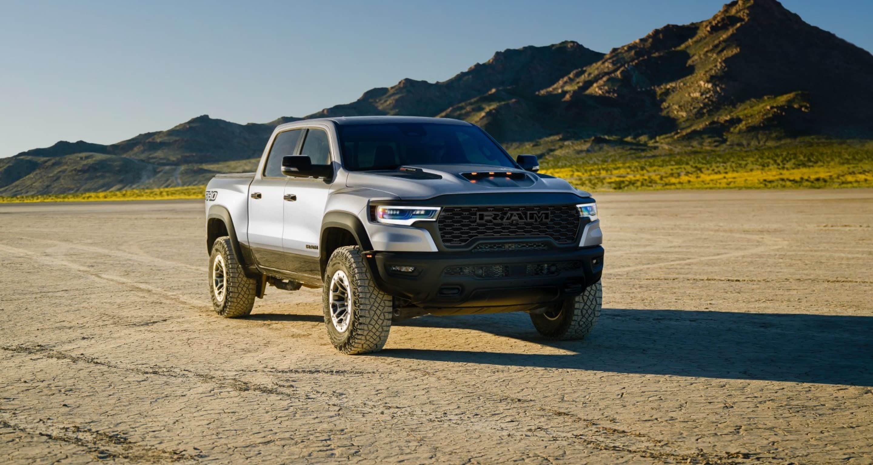 The 2027 Ram 1500 parked on a dirt path with mountains in the back ground