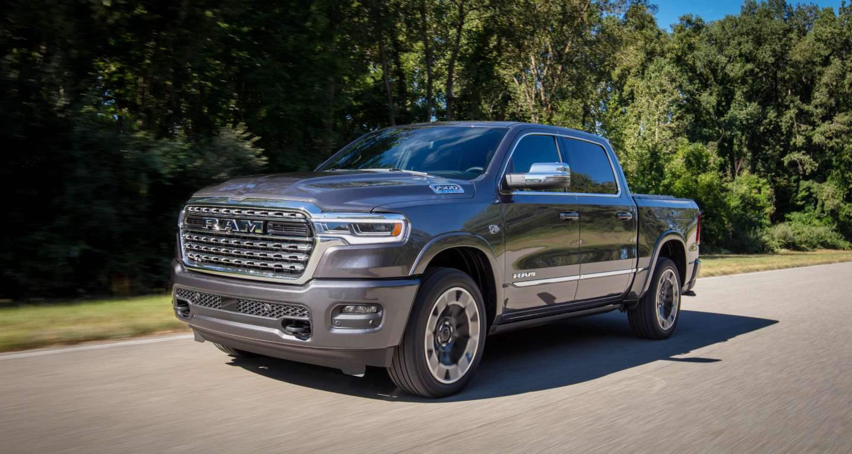 2027 Ram 1500 driving on an open road with trees in the background