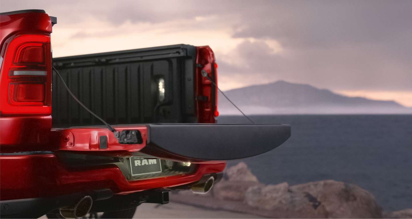 The open tailgate on a red 2027 Ram 1500 Tungsten 4x4 Crew Cab