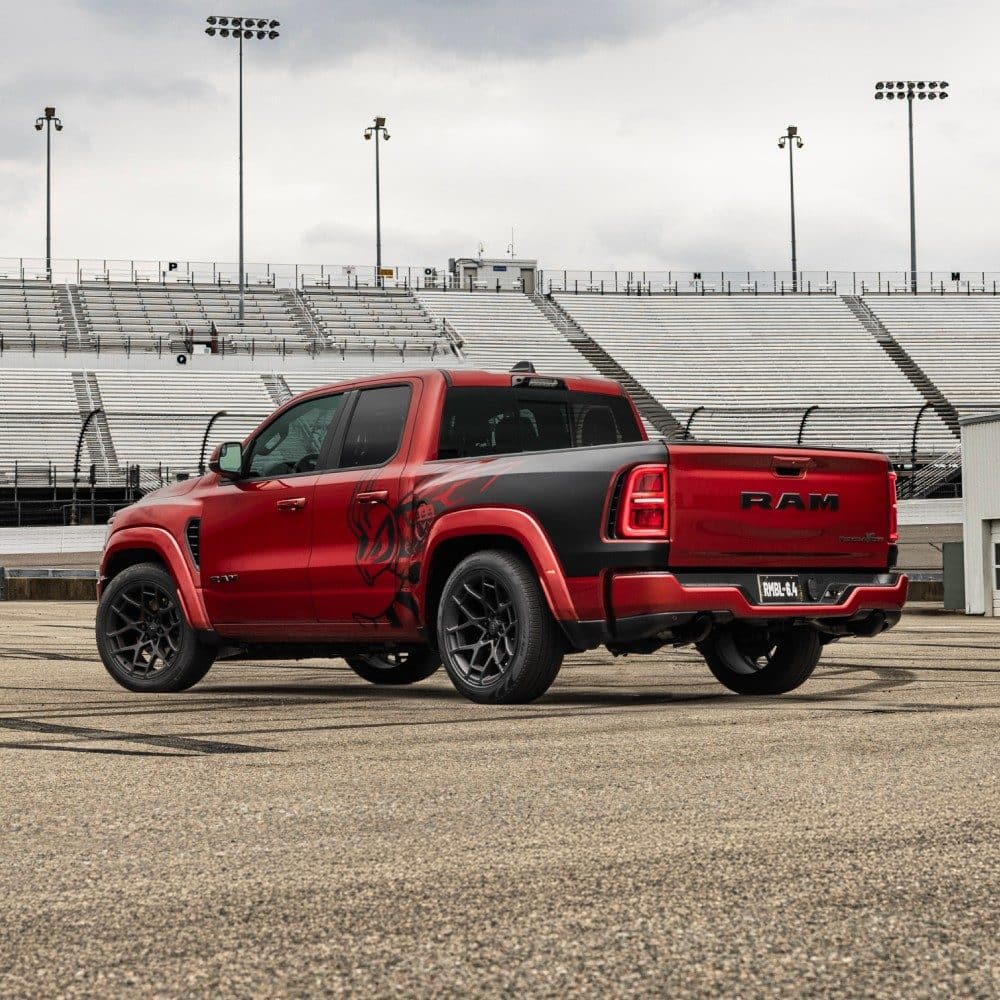 Red 2027 Ram 1500 Rumble Bee, rear three-quarter view at a racetrack