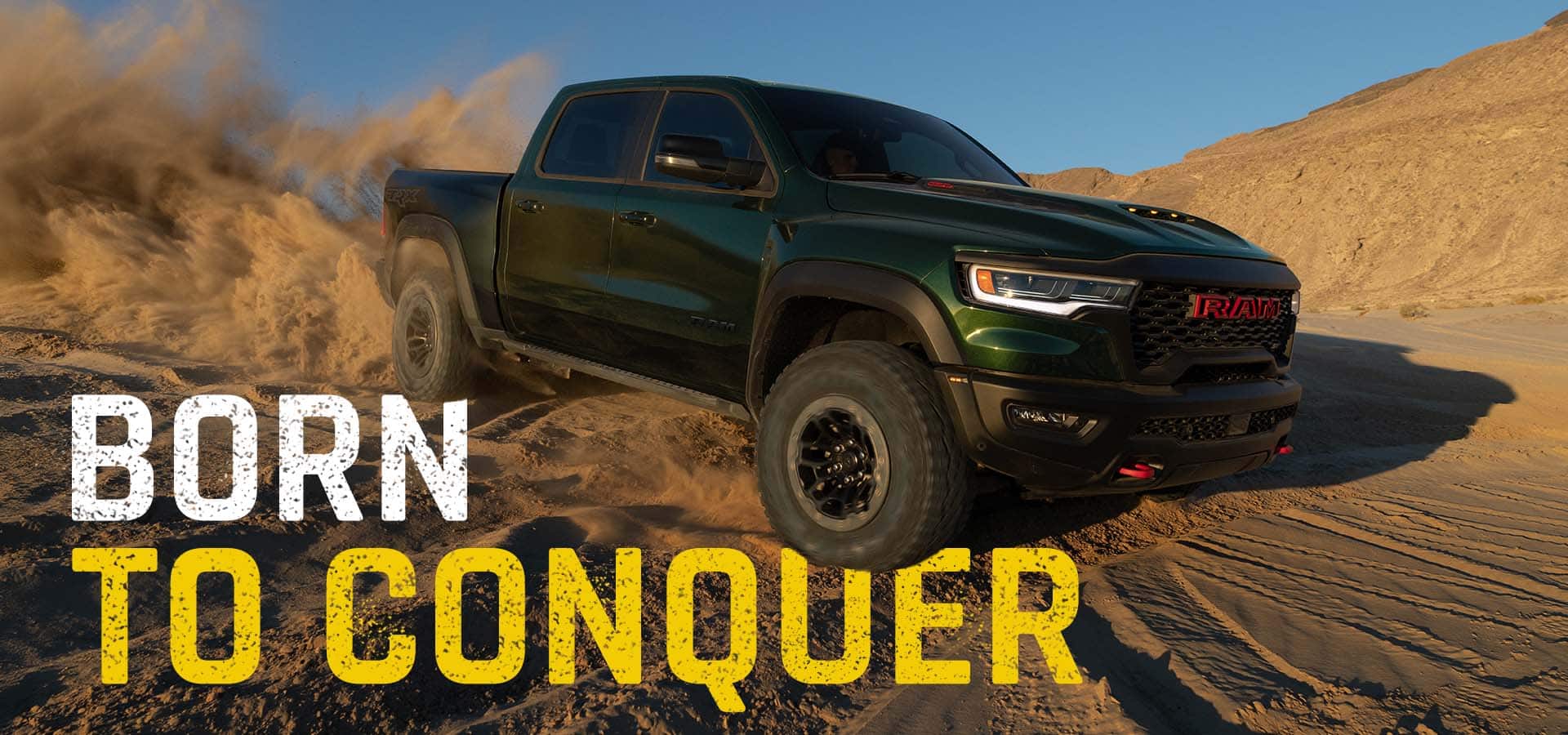 A green 2027 Ram 1500 TRX SRT traveling through the desert, kicking up sand as it goes. Born To Conquer.