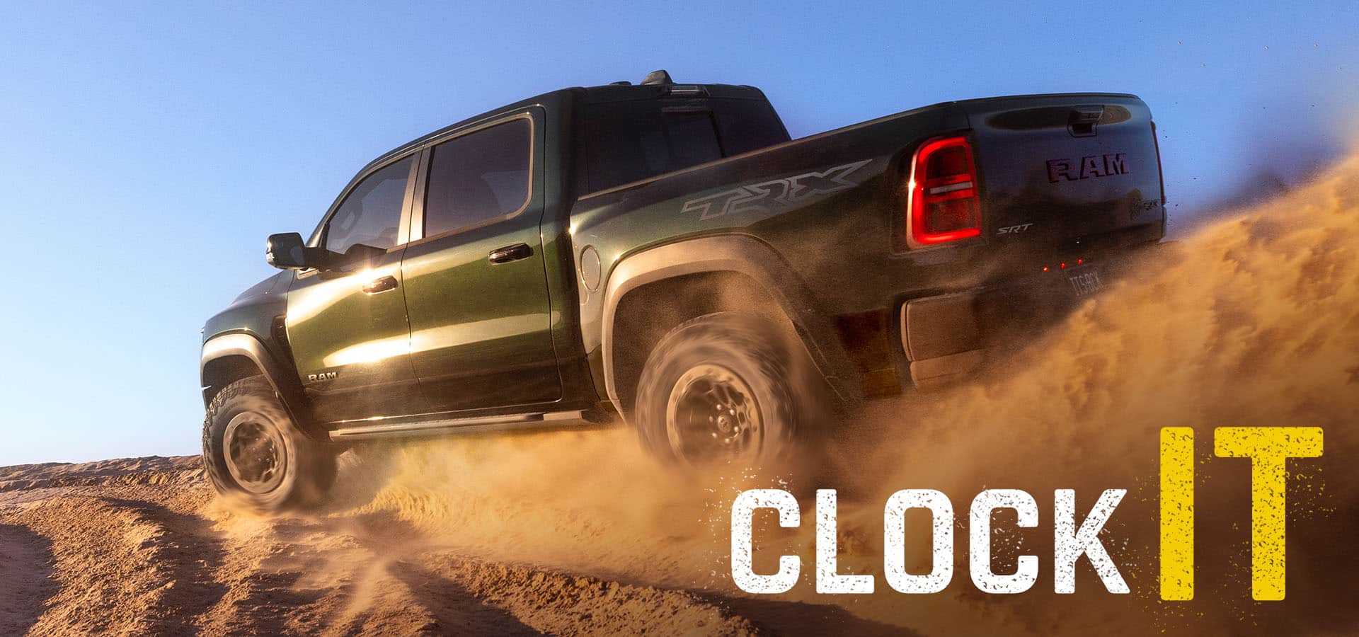 A green 2027 Ram 1500 TRX SRT taking a curve on deeply rutted sand. Clock It.