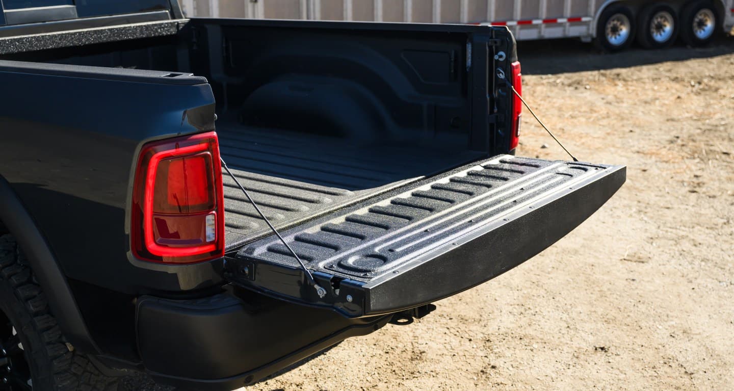 The open tailgate and bed of a 2027 Ram 2500 parked near a job site