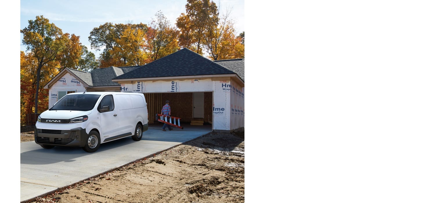 A driver-side front angle of a white 2027 Ram ProMaster City Tradesman Cargo Van parked in the driveway of a home under construction.