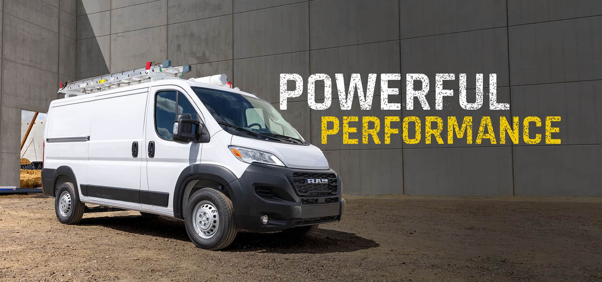 A white 2027 Ram ProMaster 2500 Tradesman Standard Roof Cargo Van with a ladder on its roof rack, at a construction site, shot on an angled passenger-side profile. Powerful Performance.
