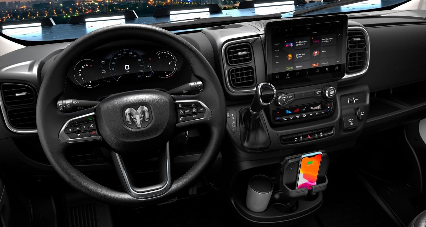 Display The steering wheel, Digital Cluster Display, Uconnect touchscreen, center stack controls, wireless charging shelf and cup holder in the 2027 Ram ProMaster Cargo Van.
