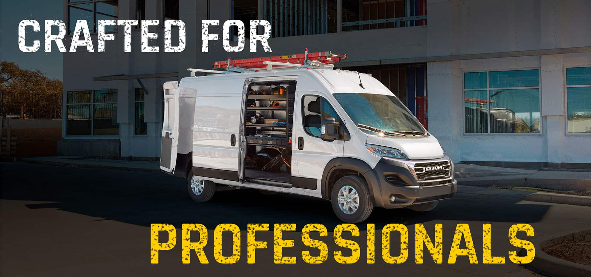 A white 2027 Ram ProMaster 3500 SLT High Roof Cargo Van, parked outside a commercial building with a red ladder on its roof rack and its passenger-side sliding door open, revealing custom shelving full of equipment. Crafted For Professionals.