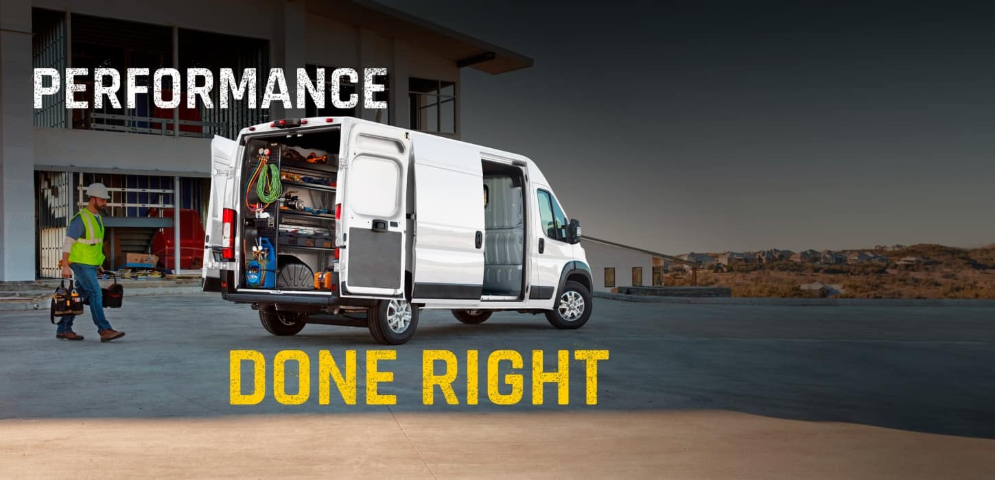 The rear of a white 2027 Ram ProMaster 2500 SLT High Roof Cargo Van with its passenger-side sliding door and rear doors open, displaying shelves full of tools and a technician walking toward the van. Performance Done Right.