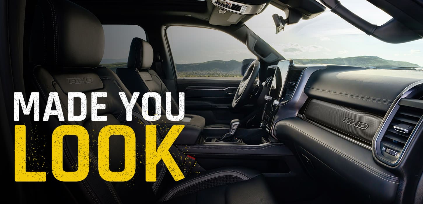 The front row of the 2027 Ram 1500 RHO 4x4 Crew Cab, shot from the passenger side. Made You Look.