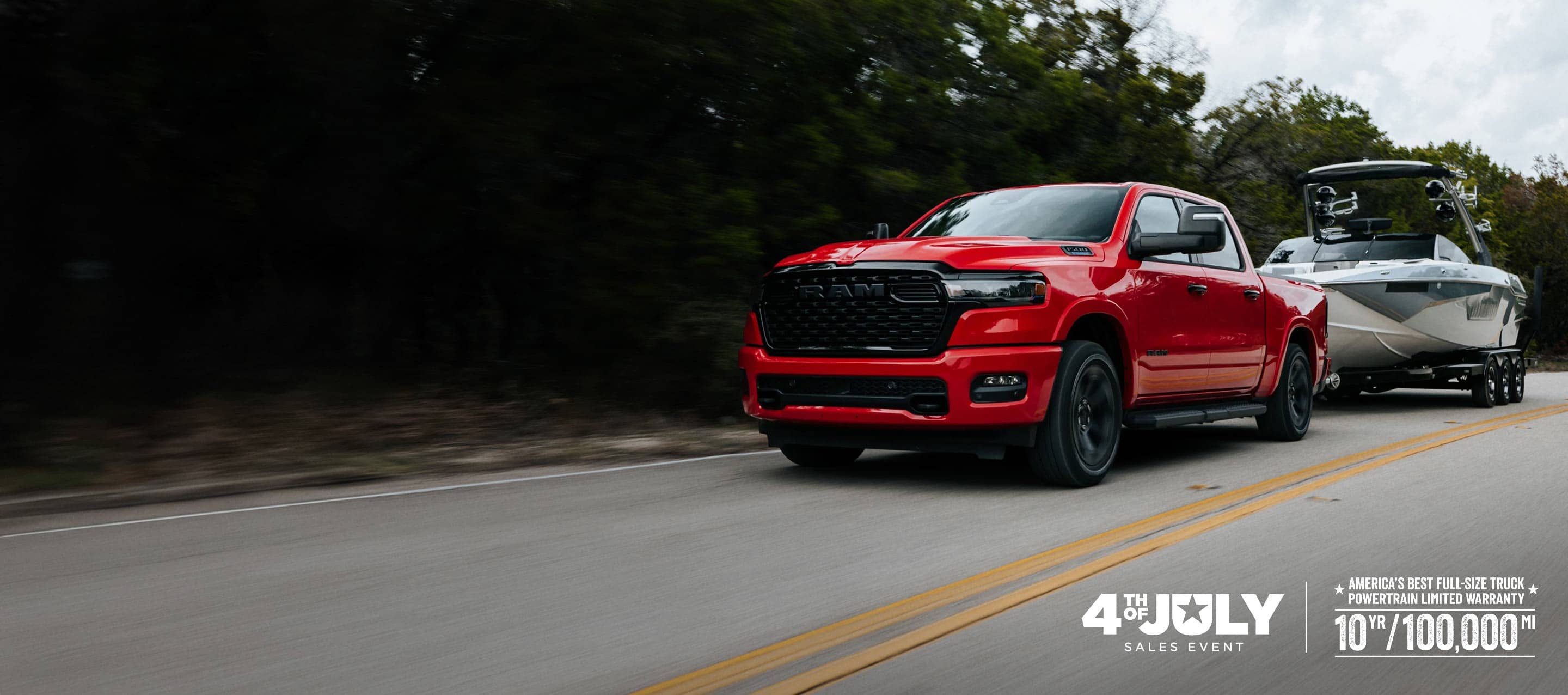 A red 2026 Ram 1500 Big Horn 4x4 Crew Cab pickup traveling down a highway, towing a motorboat. Limited Warranty—10 Years/100,000 Miles. 4th of July Sales Event.