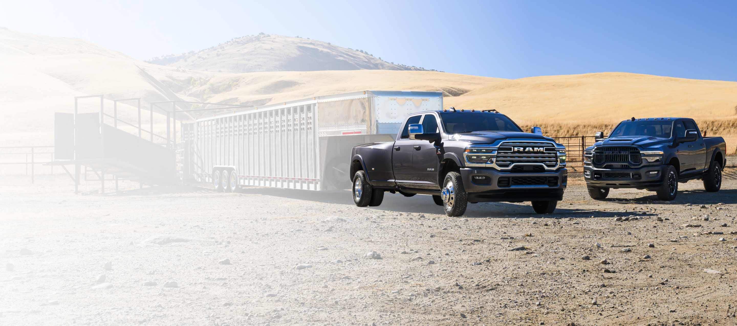 A black 2026 Ram 2500 Rebel 4x4 Crew Cab heavy-duty pickup parked at a desert ranch.