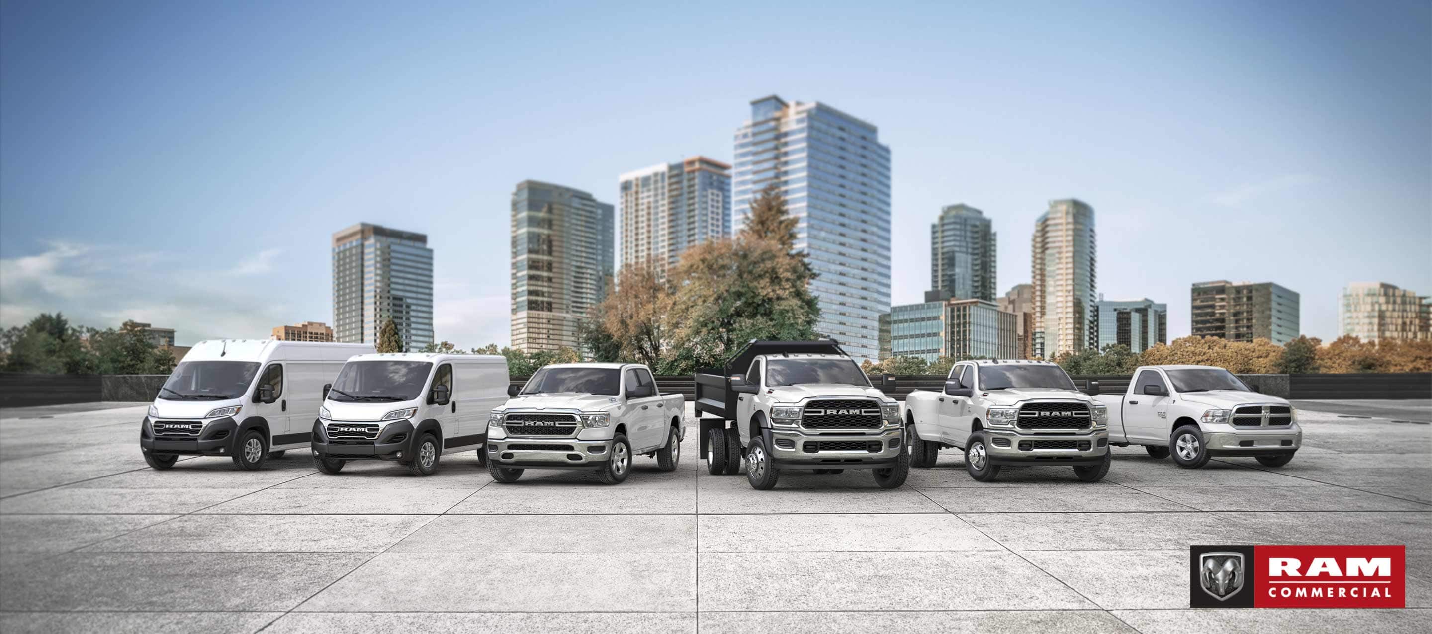 The Ram Brand lineup, all in white, parked side-by-side. Beginning on the left: a 2023 Ram ProMaster 3500 High Roof Cargo Van, 2022 Ram ProMaster City Cargo Van, 2023 Ram 1500 Tradesman Crew Cab, 2023 Ram 5500 Tradesman Regular Cab with dump body, 2023 Ram 3500 Tradesman Crew Cab and 2023 Ram 1500 Classic Regular Cab. Ram Commercial.