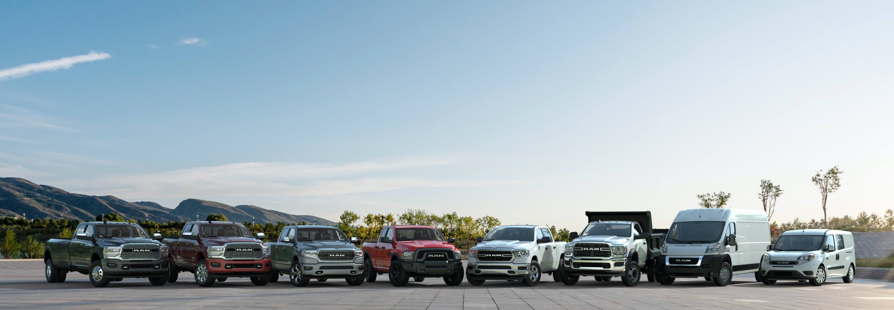 A group of 2021 Ram Brand vehicles, from left to right: three Ram Limited models-a 3500, 2500 and 1500, Ram 1500 Classic Warlock, two Tradesman models-a Ram 1500 and Chassis Cab 5500-both with the Chrome Appearance Package, a Ram ProMaster 2500 Cargo Van and Ram ProMaster City Passenger Wagon.