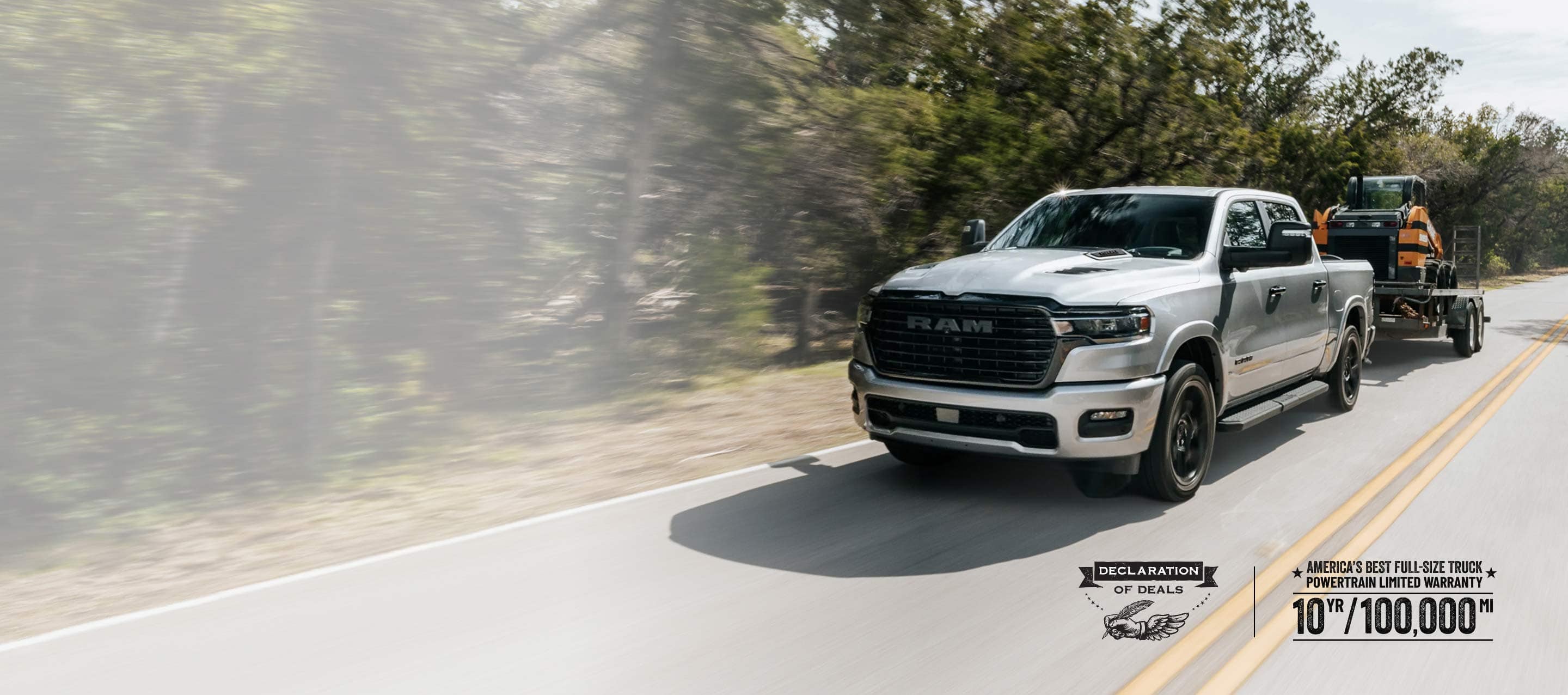 A silver 2026 Ram 1500 Laramie 4x4 Crew Cab traveling down a highway, towing a skidsteer loader. Limited Warranty—10 Years/100,000 Miles. Declaration of deals Sales Event.