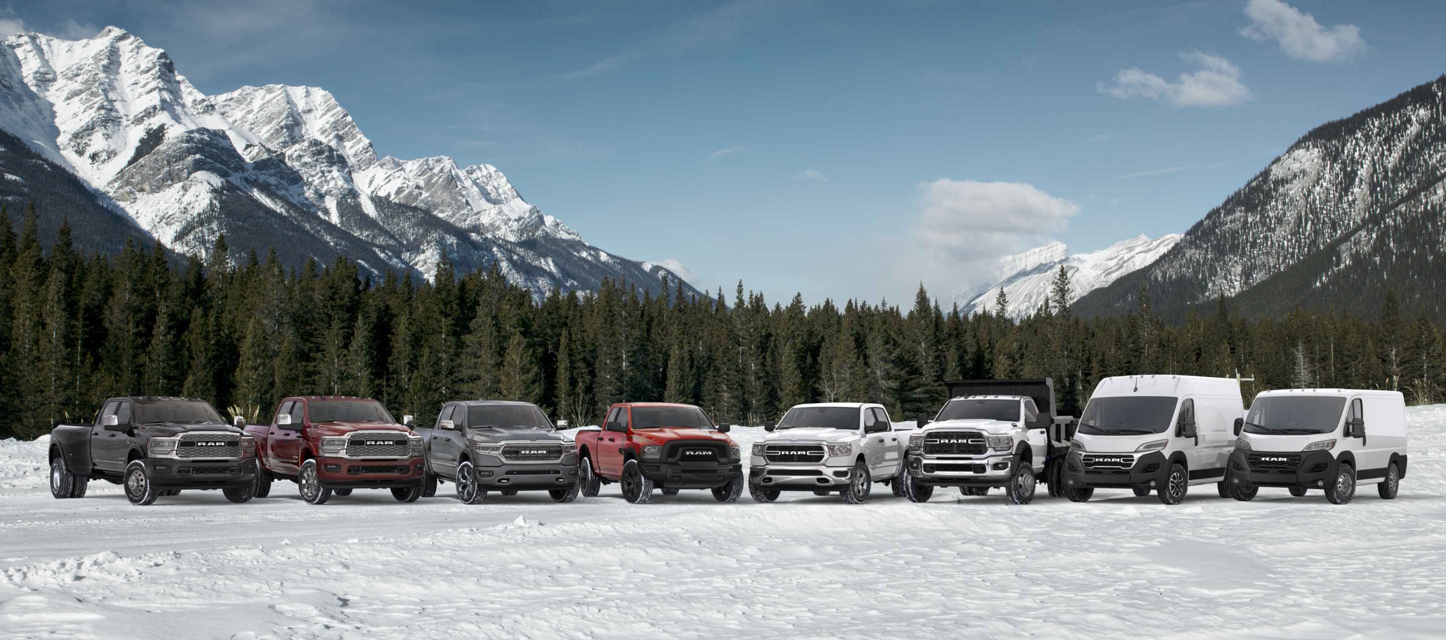 The 2024 lineup of six Ram trucks and two Ram vans parked in a semicircle on a snow-covered clearing, with mountains and evergreen trees in the background. From left to right: Three Ram Limited 4x4 Crew Cabs – a 3500, 2500 and 1500 followed by a Ram 1500 Classic Warlock 4x4 Quad Cab, a Ram 1500 Tradesman 4x4 Crew Cab, a Ram 5500 Tradesman 4x2 Chassis Cab with Dump Body, a Ram ProMaster Cargo Van High Roof and a Ram ProMaster Cargo Van Standard Roof. Ram Wrap Up the Year Sales Event.
