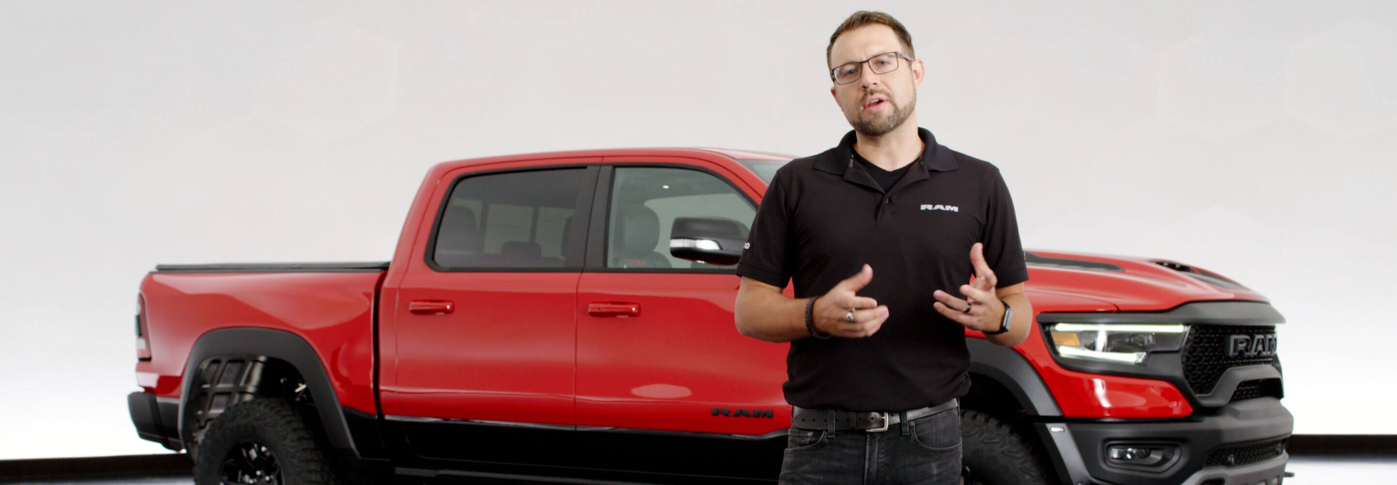 Ryan Nagode, Chief Designer of Ram Interiors standing in front of a 2021 Ram 1500 TRX.